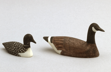 Fig. 16 Walrus ivory carvings of Canada goose and merganser, with dyed incisions to mark eyes and feathers. 